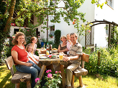 Familie am Tisch im Garten