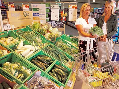 Kundinnen am Bio-Gemüseregal eines Supermarktes